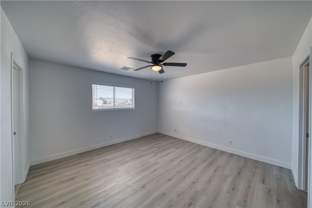 851 Lone Pine Road Pahrump, NV 89048 - Photo 21 of 25 Bright and airy, this room features durable flooring and a refreshing ceiling fan.