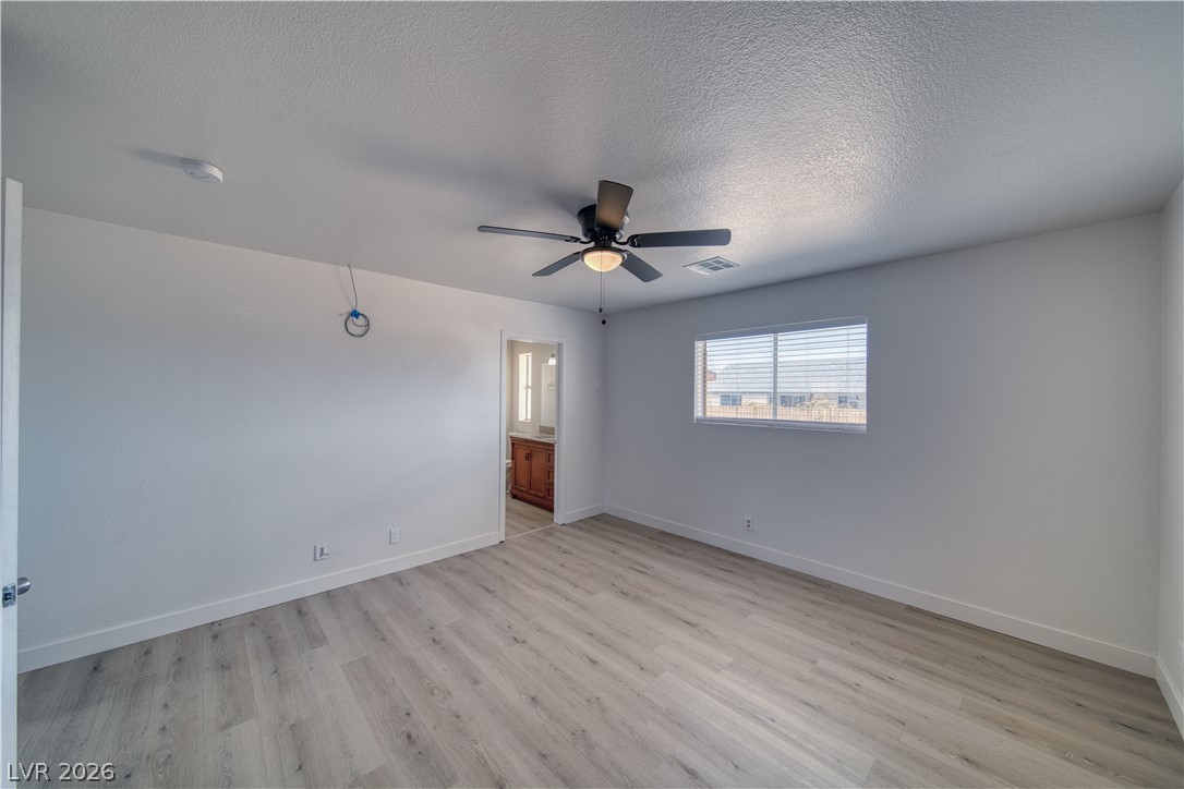 851 Lone Pine Road Pahrump, NV 89048 - Photo 22 of 25 This spacious bedroom offers comfortable living with elegant flooring and ample natural light.