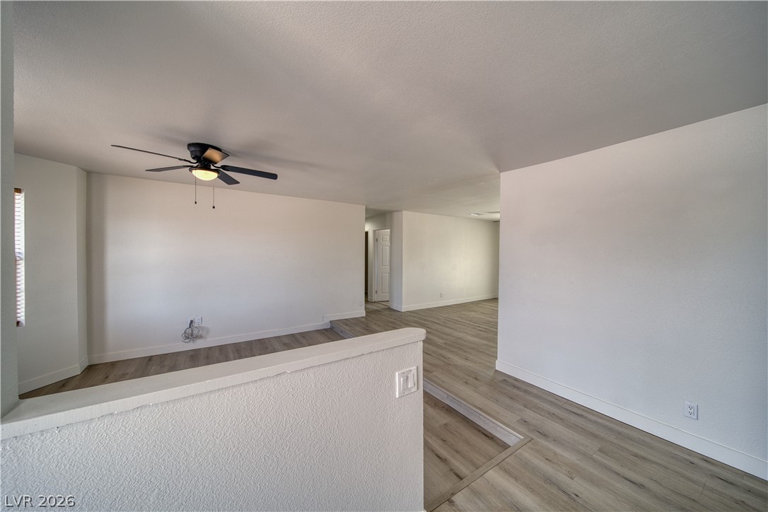 851 Lone Pine Road Pahrump, NV 89048 - Photo 6 of 25 This living area features durable flooring and bright walls, offering a versatile space.