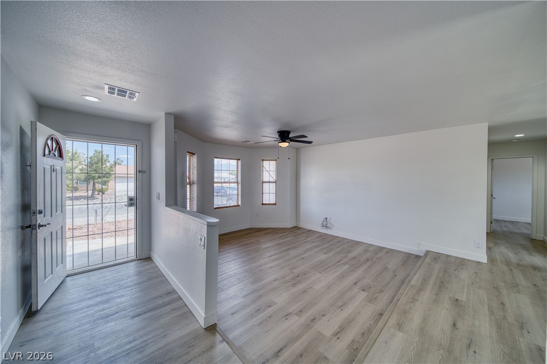851 Lone Pine Road Pahrump, NV 89048 - Photo 7 of 25 This bright and airy living space welcomes you with light wood-style flooring and abundant natural light.