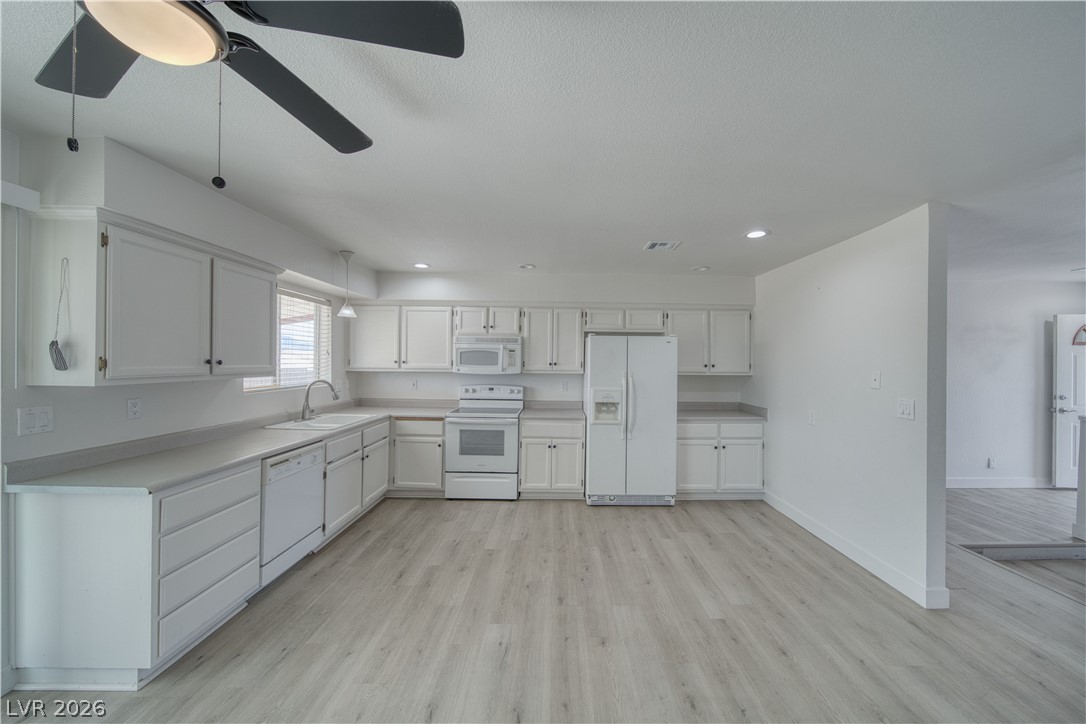 851 Lone Pine Road Pahrump, NV 89048 - Photo 10 of 25 Bright and airy kitchen features abundant cabinetry and modern appliances, perfect for everyday living.