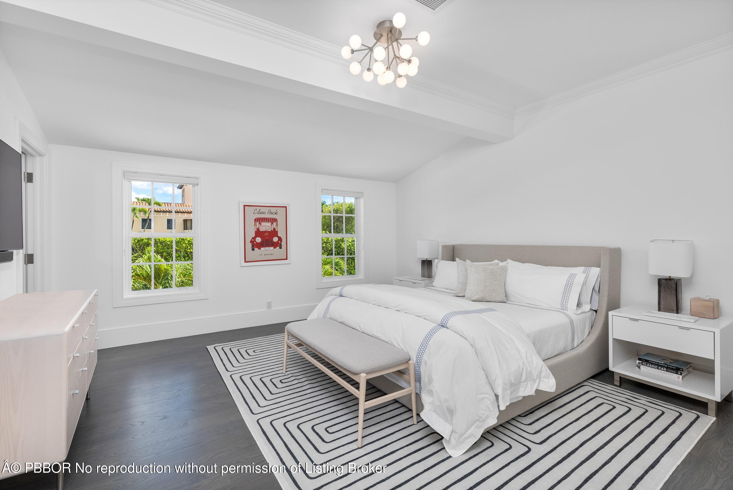 201 Banyan Road Palm Beach, FL 33480 - Photo 23 of 42 a spacious bedroom with a bed chandelier and a window