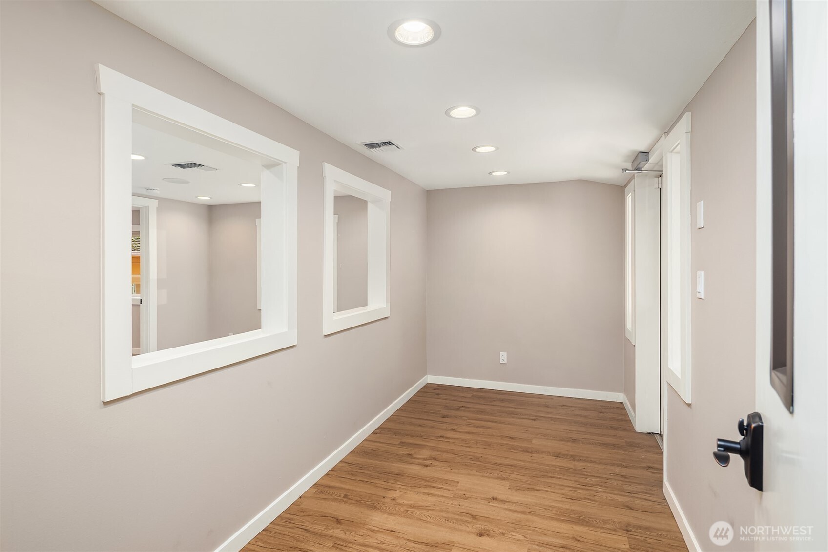 19007 Yew Way Snohomish, WA 98296 - Photo 12 of 27 a view of a hallway with wooden floor and a bathroom
