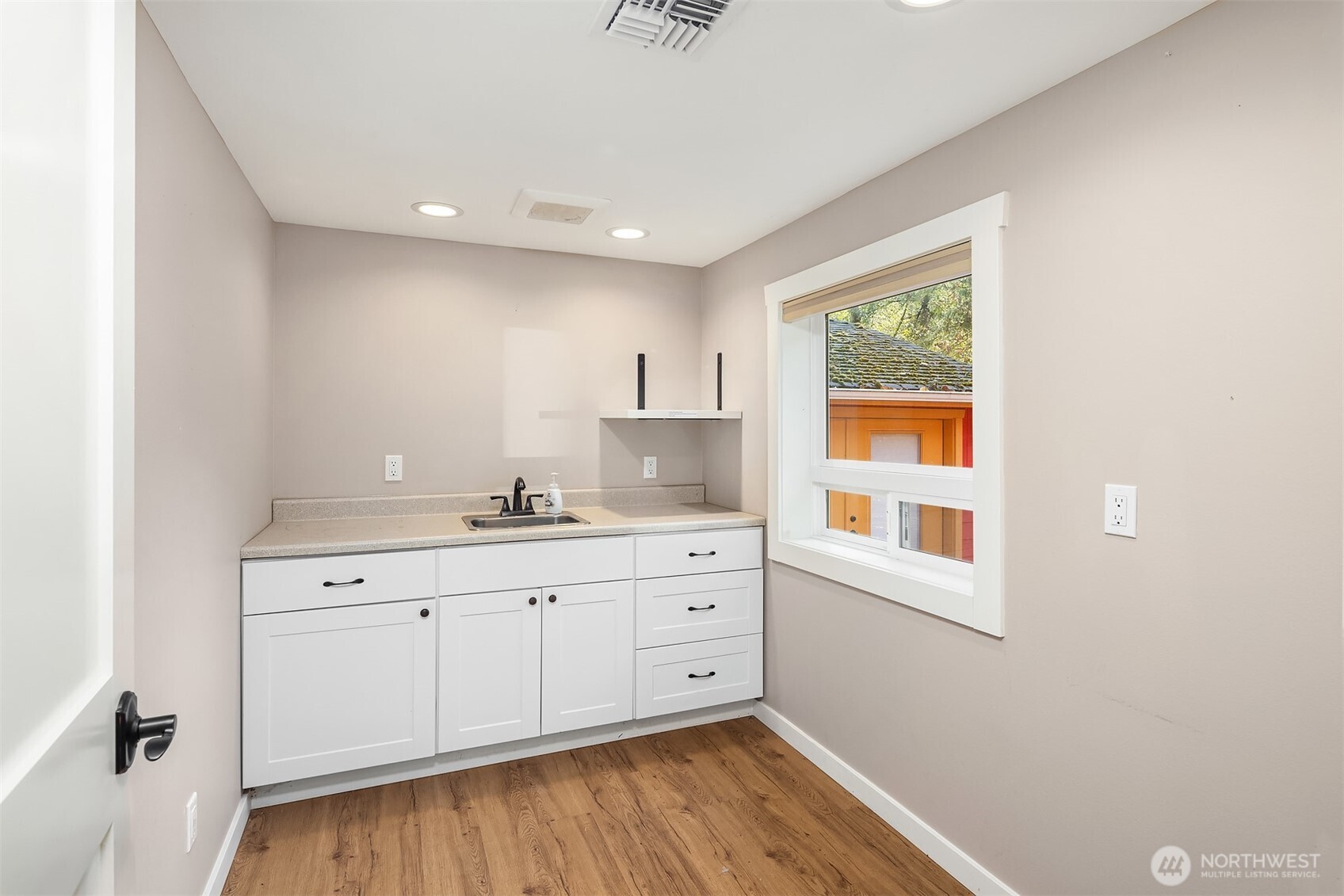 19007 Yew Way Snohomish, WA 98296 - Photo 14 of 27 a room with a sink cabinets and wooden floor