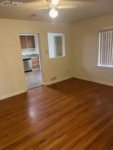 wooden floor in an empty room with a window