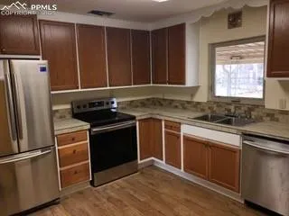a kitchen with a refrigerator and a sink