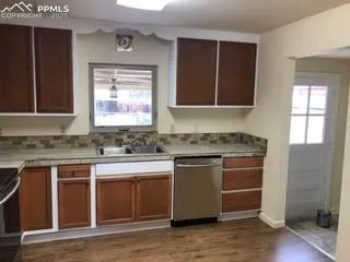 a kitchen with a sink cabinets and window