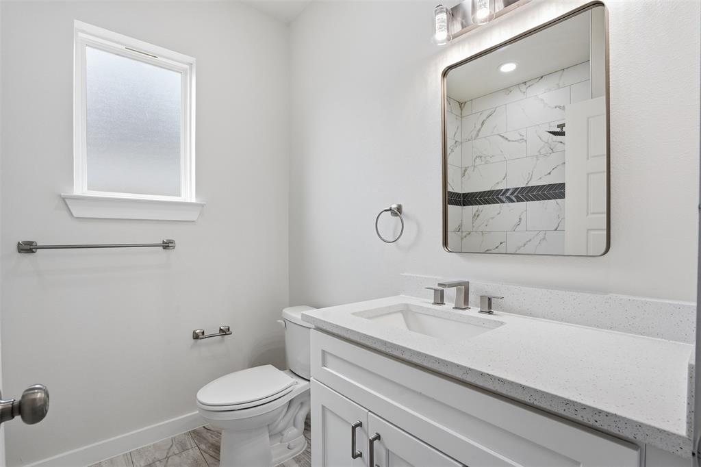 532 Highview Court Godley, TX 76044 - Photo 9 of 39 Bathroom featuring a single vanity with a white countertop, undermount sink, and brushed nickel fixtures
