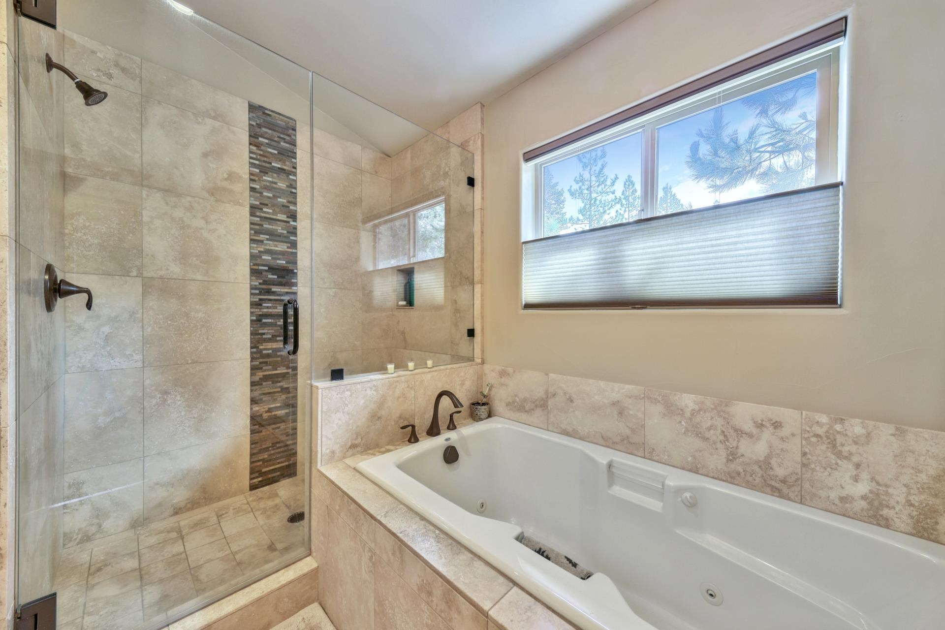 14152 Ski View Loop Truckee, CA 96161 - Photo 15 of 28 a bathroom with a tub a sink and glass door