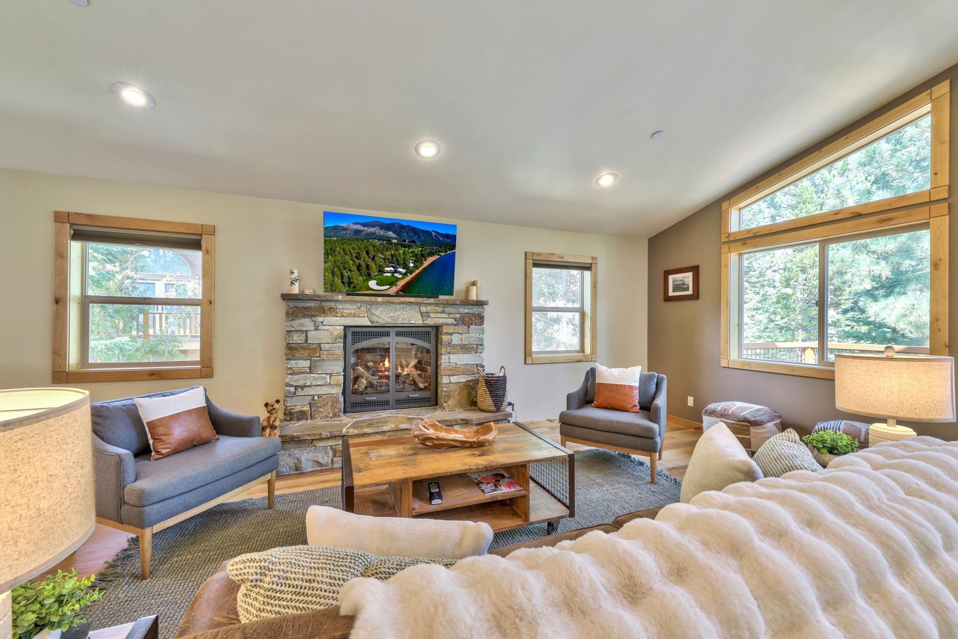 14152 Ski View Loop Truckee, CA 96161 - Photo 8 of 28 a living room with furniture a fireplace and a large window