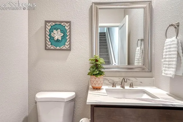 a bathroom with a sink vanity and toilet