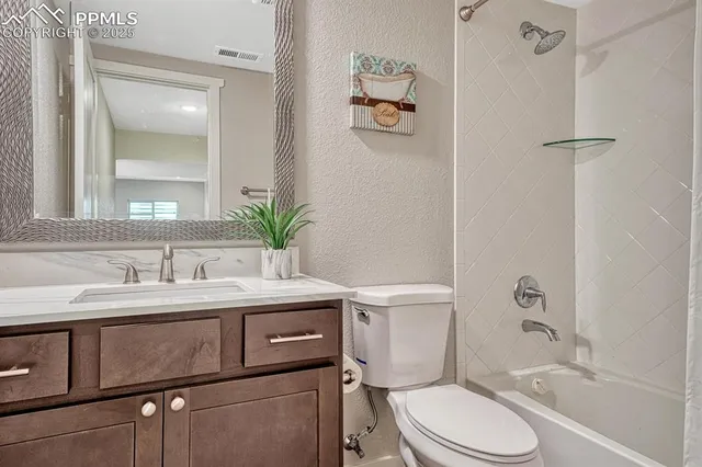 a bathroom with a sink vanity mirror and toilet