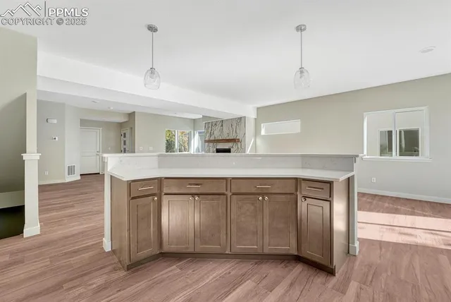 a kitchen with a sink cabinets and wooden floor