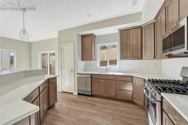 a kitchen with stainless steel appliances granite countertop a sink and stove top oven