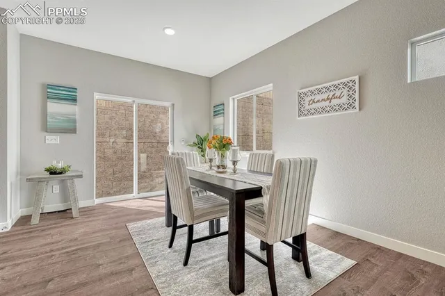 a view of a dining room with furniture window and wooden floor