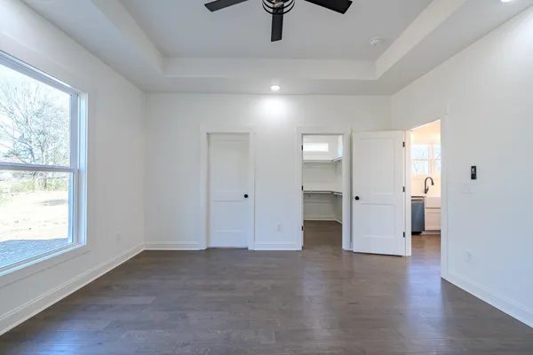 a bathroom with a tub shower sink and vanity