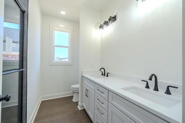 an empty room with a ceiling fan and carpet