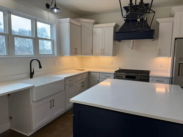 a kitchen with stainless steel appliances a sink a stove and a refrigerator