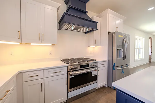 a large kitchen with a refrigerator a sink and dishwasher