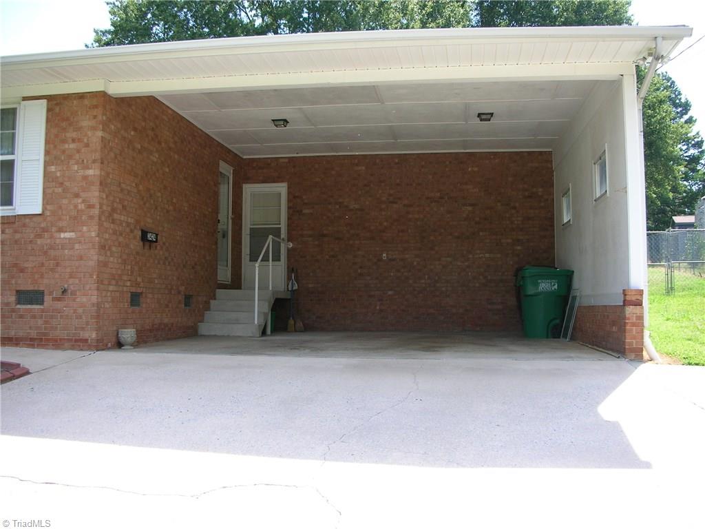 3424 Pine Valley Road High Point, NC 27265 - Photo 14 of 30 Here you are looking into the carport where you can see the door to the left is the entryway into the home and the other door is to the laundry/mechanical room. See here you can get in and out of your car and still be out of the rain and wind.