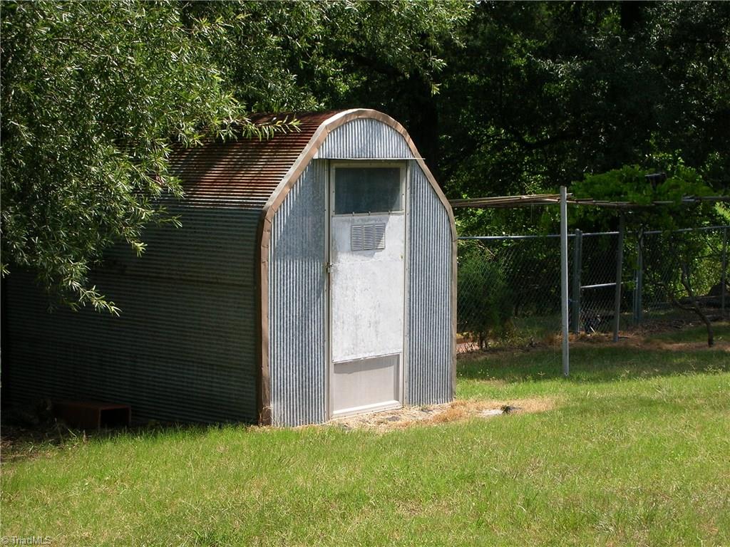 3424 Pine Valley Road High Point, NC 27265 - Photo 22 of 30 This is the other storage building that is located in the back left hand corner of the backyard. So you have a lot of storage space back here for yard, garden equipment and a place to store some of the kids toys.