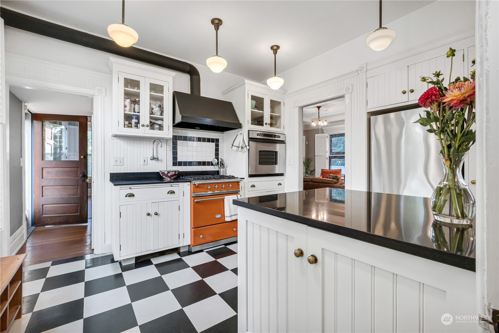 a kitchen with stainless steel appliances granite countertop a sink a stove a refrigerator and cabinets