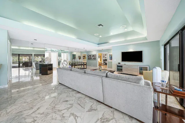 a dining room with furniture and a floor to ceiling window