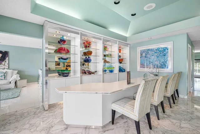 a kitchen with white cabinets stainless steel appliances and a window