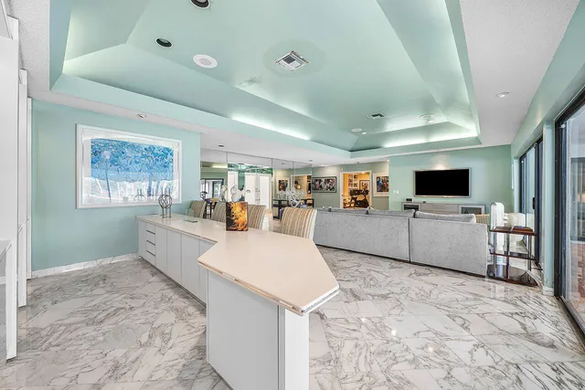 a kitchen with stainless steel appliances granite countertop a refrigerator and a sink