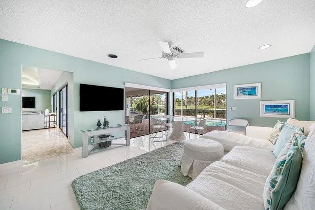 a large bedroom with a large bed and a flat tv screen