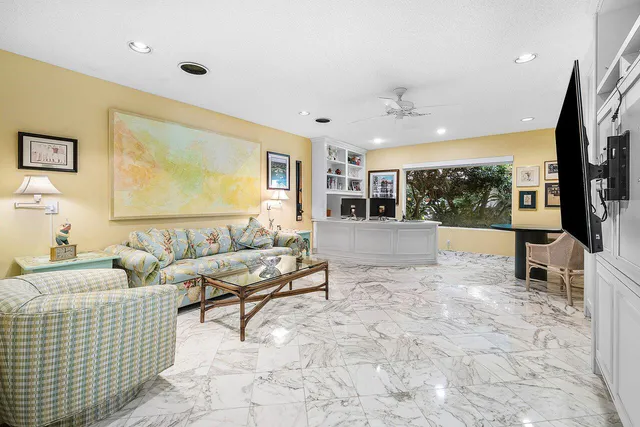 a spacious bedroom with a bed a couch and large window