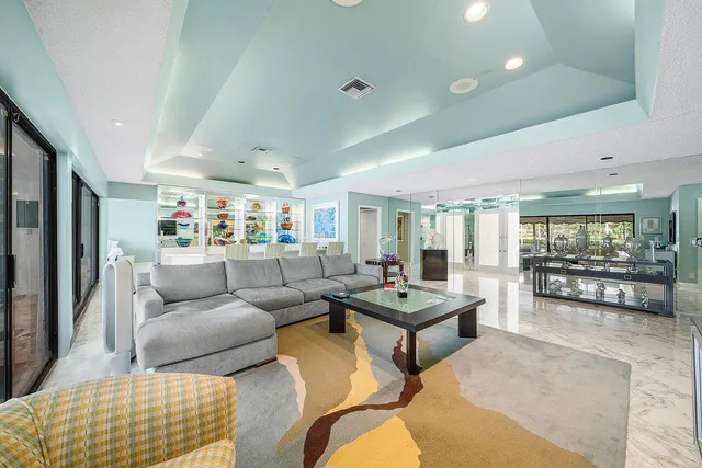 a living room with furniture large window and flat screen tv