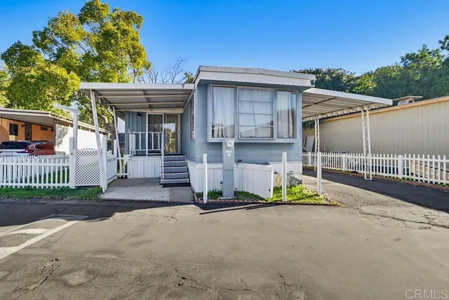 a view of a house with a wooden fence