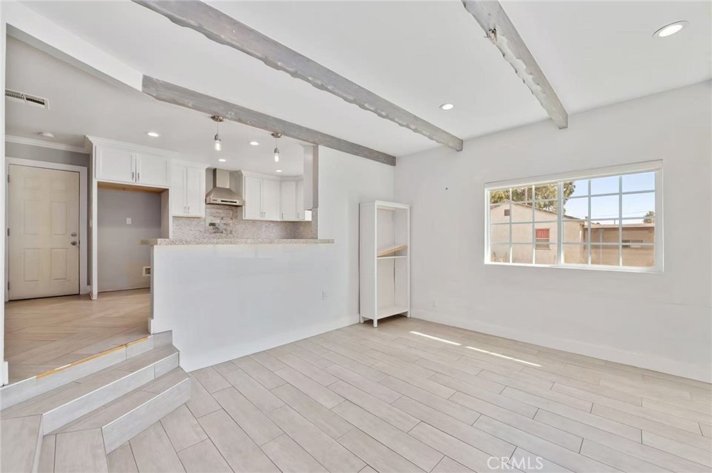 10566 Calabash Avenue Fontana, CA 92337 - Photo 4 of 20 a view of a kitchen with wooden floor and windows