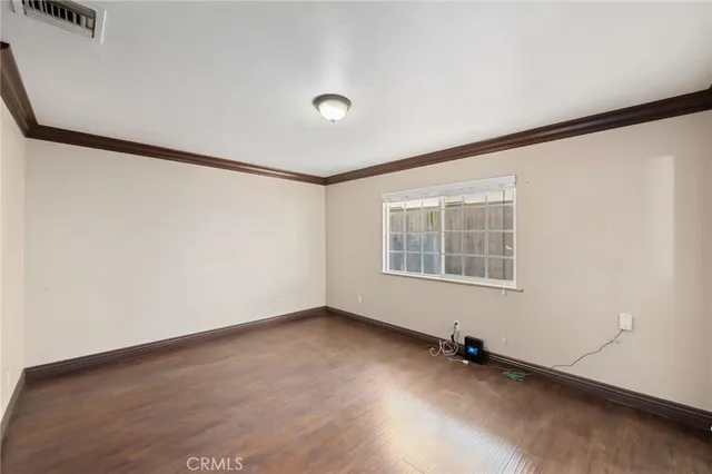 an empty room with a window and ceiling fan