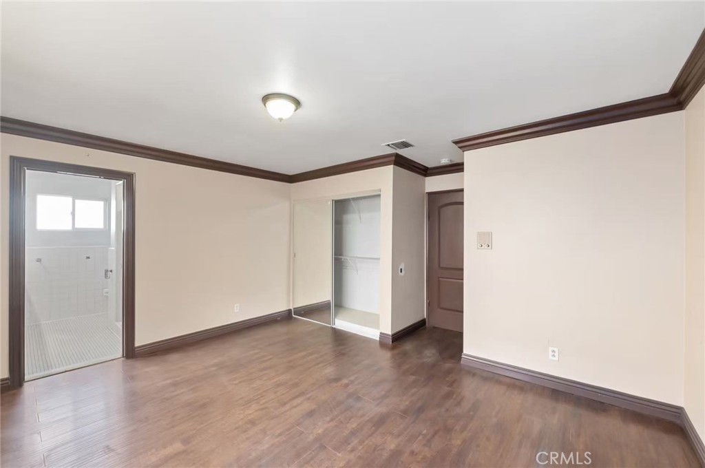 10566 Calabash Avenue Fontana, CA 92337 - Photo 8 of 20 an empty room with wooden floor and windows