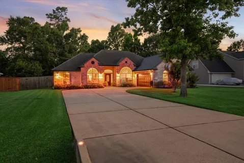 a front view of house with yard and green space