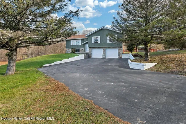 a front view of a house with a yard and garage
