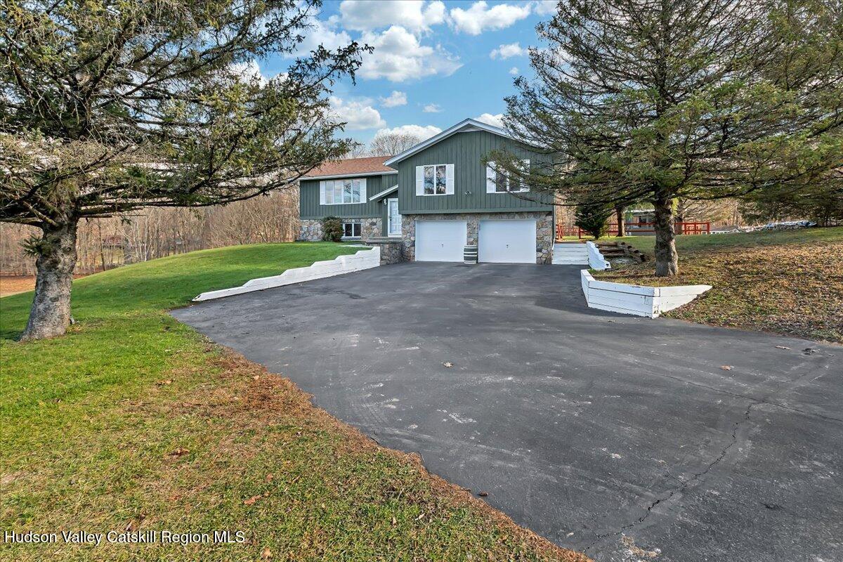 a front view of a house with a yard and garage