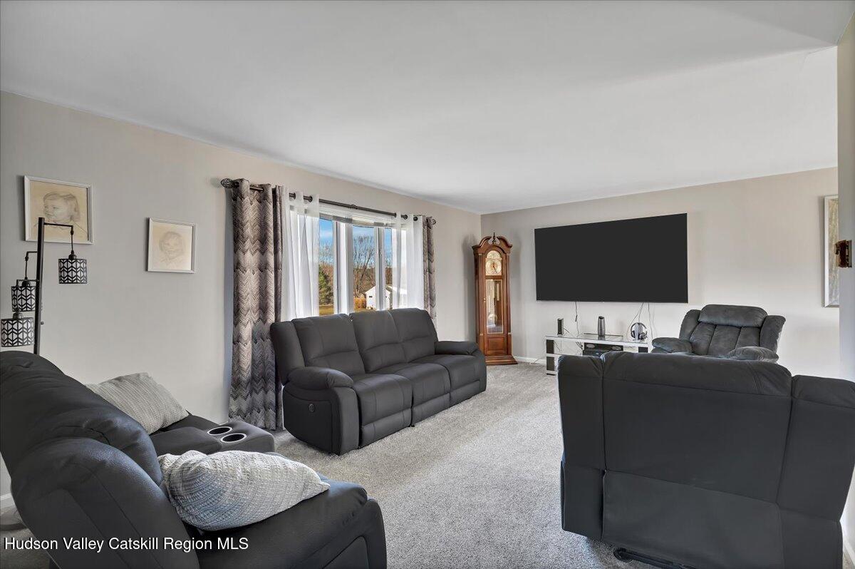 28 Hennett Road Valatie, NY 12184 - Photo 11 of 40 a living room with furniture and a flat screen tv