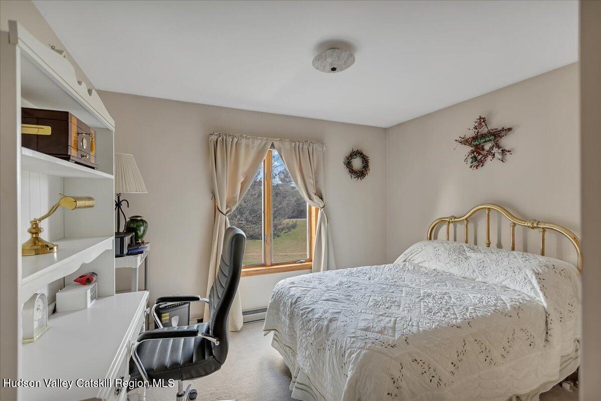 28 Hennett Road Valatie, NY 12184 - Photo 14 of 40 a bedroom with a bed furniture and a window