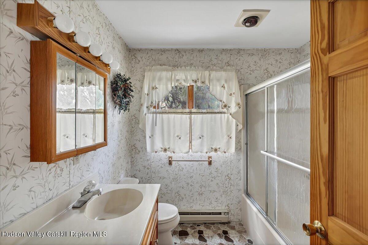 28 Hennett Road Valatie, NY 12184 - Photo 16 of 40 a bathroom with a granite countertop sink a toilet and shower
