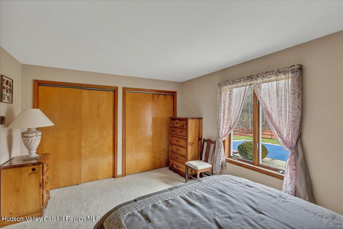 28 Hennett Road Valatie, NY 12184 - Photo 18 of 40 a bedroom with a bed and a large window