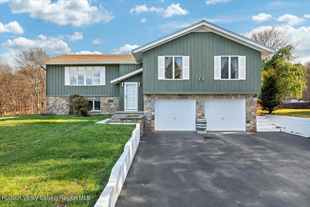 28 Hennett Road Valatie, NY 12184 - Photo 36 of 40 a front view of a house with a yard and garage
