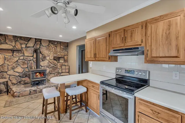 a kitchen with stainless steel appliances granite countertop a stove a refrigerator and a microwave