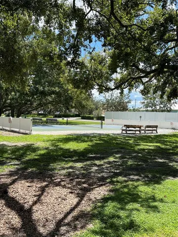 a view of a green field with lots of trees