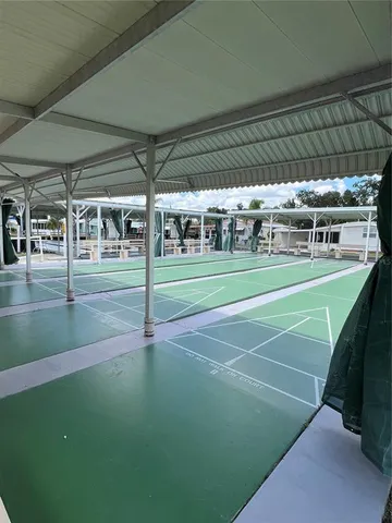 a view of a swimming pool with chairs in patio