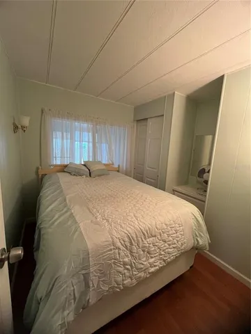 a large bed sitting in a room next to a window