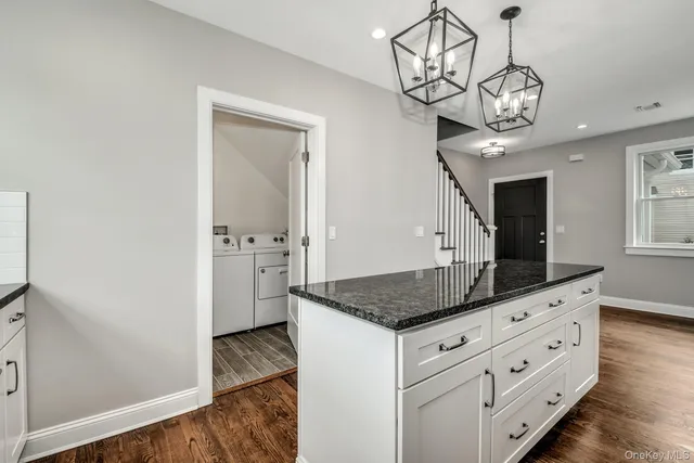 a kitchen with cabinets appliances and a counter top space