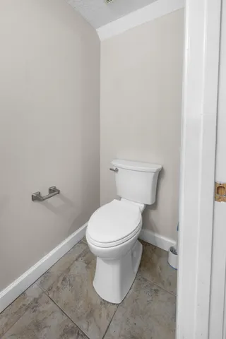 a white toilet sitting next to a white cabinet